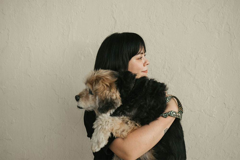 Woman hugging furry dog